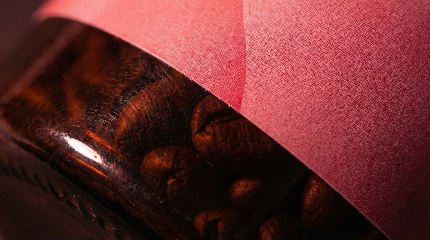 Love Potion jar seen from above revealing roasted beans inside under moody lighting