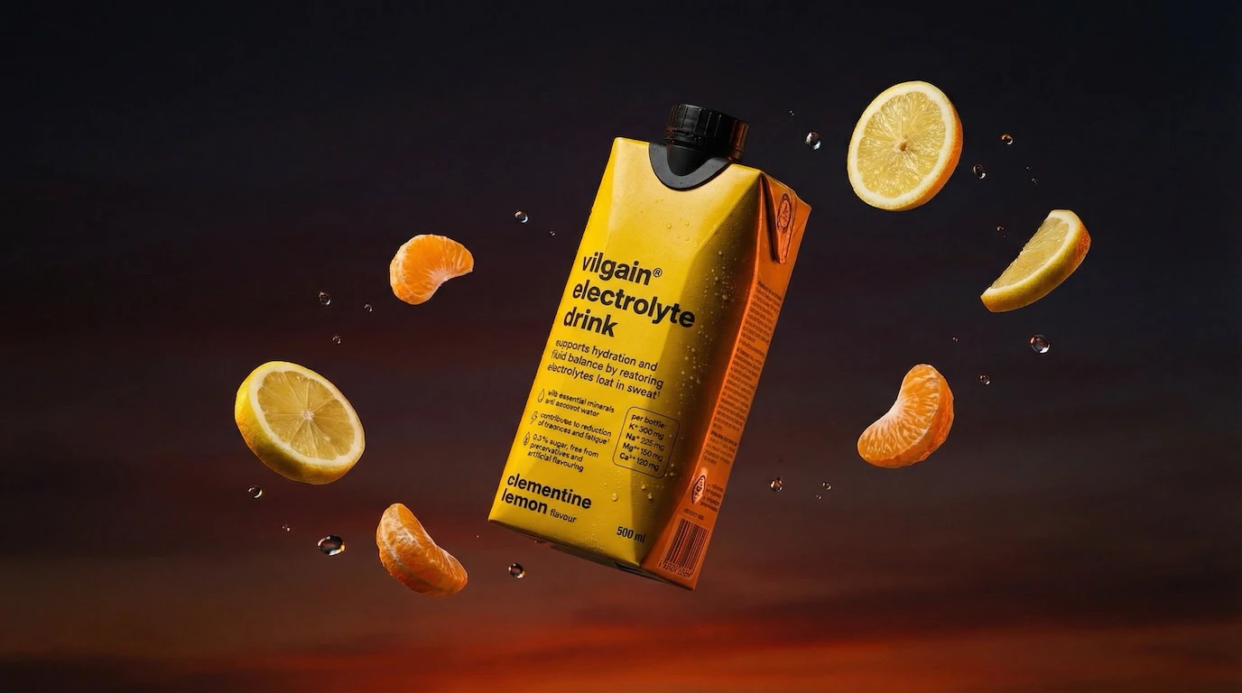 Electrolyte drink with floating citrus fruit and water droplets